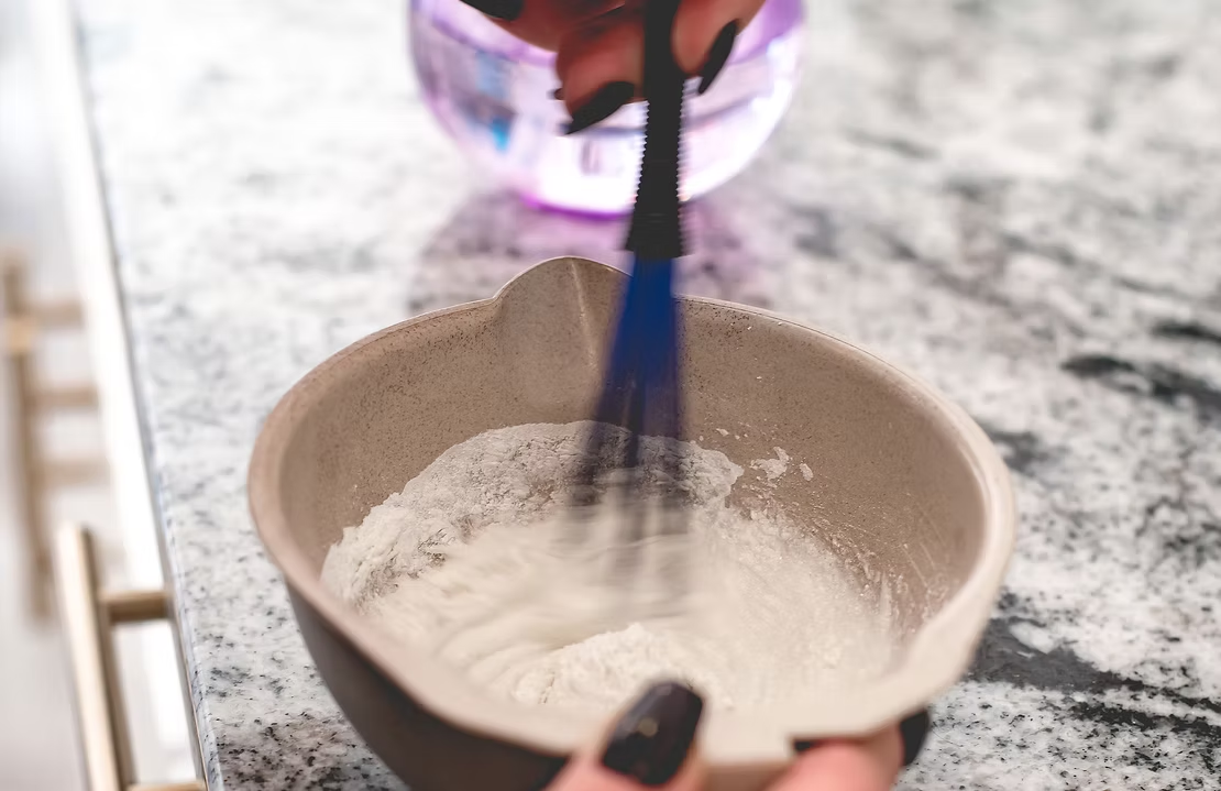 Professional hair color mixing at Karmaic Beauty Newport